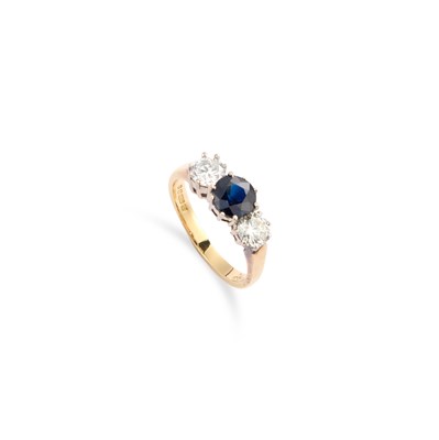 Lot 233 - AN 18 CARAT GOLD SAPPHIRE AND DIAMOND THREE STONE RING