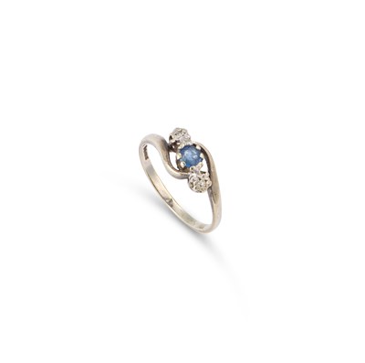 Lot 579 - A 9 CARAT WHITE GOLD THREE STONE SAPPHIRE AND DIAMOND RING