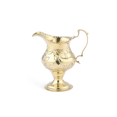 Lot 308 - A GEORGE III SILVER-GILT CREAM JUG