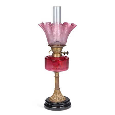 Lot 221 - A LATE VICTORIAN BRASS AND CRANBERRY GLASS OIL LAMP