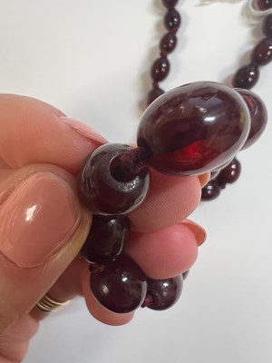 Lot 870 - A CHERRY AMBER BAKELITE BEAD NECKLACE