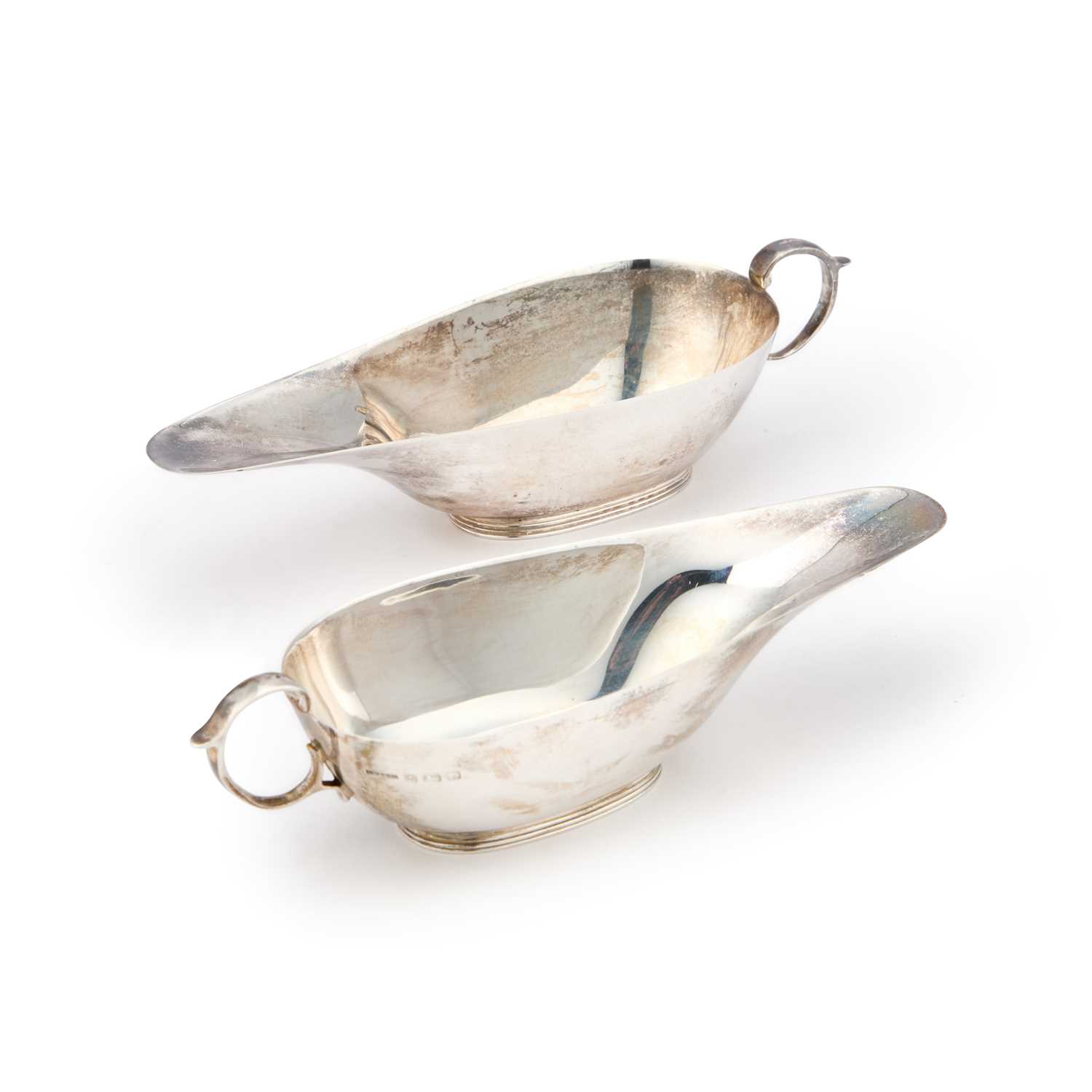 Lot 413 - A PAIR OF GEORGE V SILVER CREAM BOATS