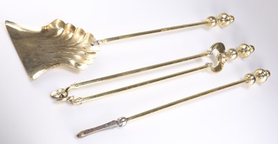 Lot 25 - A SET OF THREE GEORGIAN STYLE BRASS FIRE IRONS