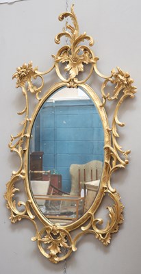 Lot 451 - A ROCOCO STYLE GILT-COMPOSITION MIRROR