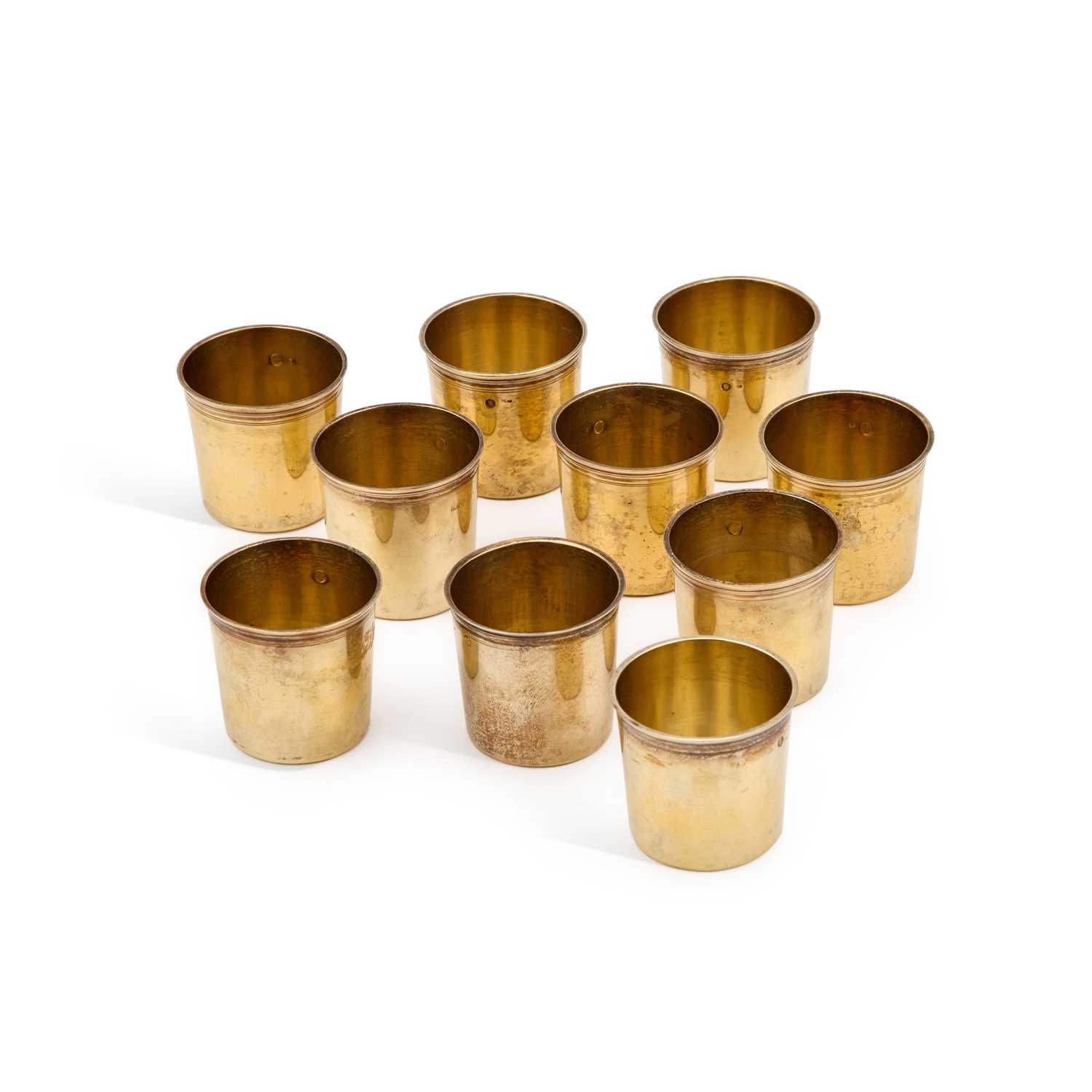 Lot 554 - A SET OF TEN FRENCH EMPIRE SILVER-GILT BEAKERS