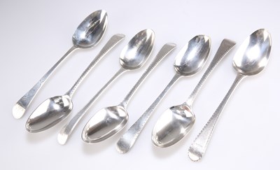 Lot 1167 - A GROUP OF SEVEN GEORGIAN BRIGHT-CUT SILVER TABLE SPOONS