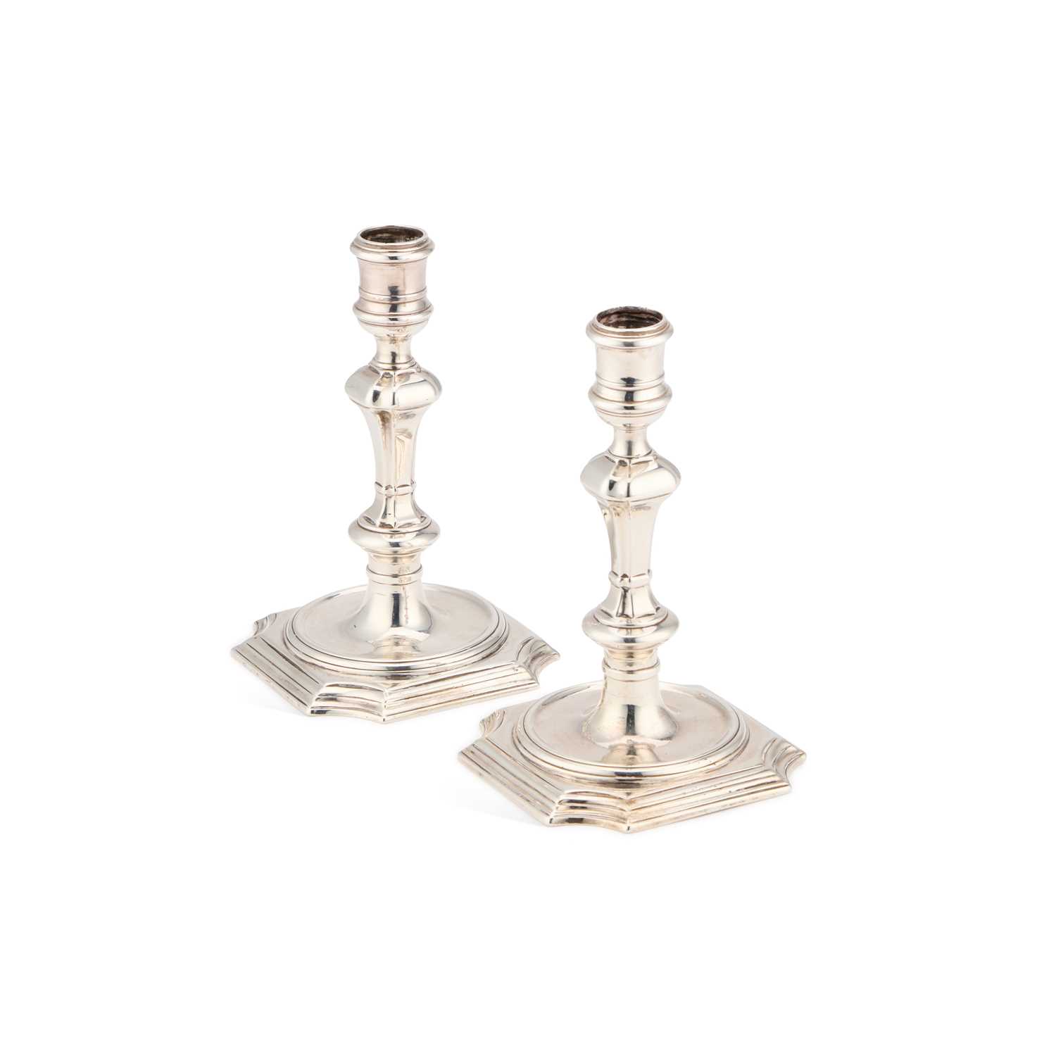 Lot 227 - A PAIR OF GEORGE II PROVINCIAL CAST SILVER CANDLESTICKS