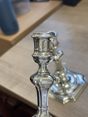 Lot 227 - A PAIR OF GEORGE II PROVINCIAL CAST SILVER CANDLESTICKS