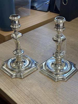 Lot 227 - A PAIR OF GEORGE II PROVINCIAL CAST SILVER CANDLESTICKS