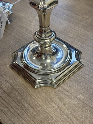 Lot 227 - A PAIR OF GEORGE II PROVINCIAL CAST SILVER CANDLESTICKS
