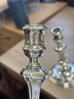 Lot 227 - A PAIR OF GEORGE II PROVINCIAL CAST SILVER CANDLESTICKS