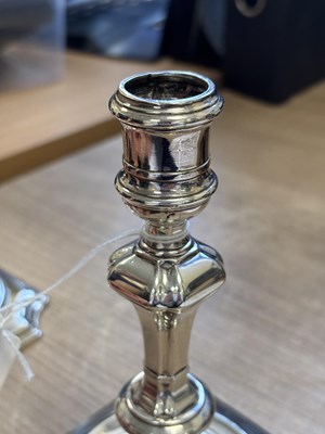 Lot 227 - A PAIR OF GEORGE II PROVINCIAL CAST SILVER CANDLESTICKS