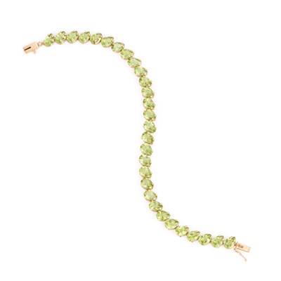 Lot 554 - A PERIDOT LINE BRACELET