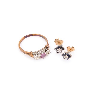Lot 280 - A 9 CARAT GOLD RUBY AND DIAMOND THREE STONE RING