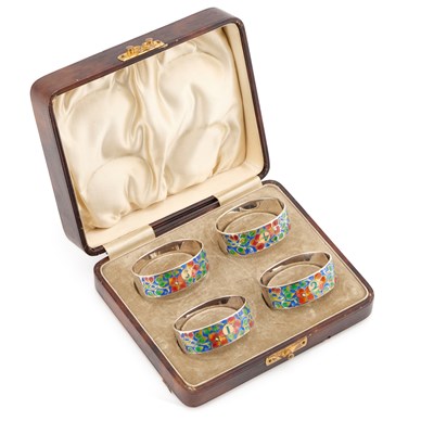 Lot 264 - A SET OF FOUR ARTS AND CRAFTS SILVER AND ENAMEL NAPKIN RINGS