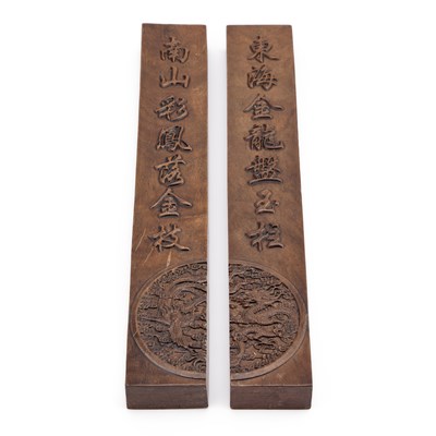 Lot 132 - A PAIR OF CHINESE HARDWOOD SCROLL WEIGHTS