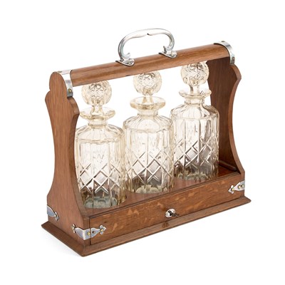 Lot 541 - A SILVER-PLATE MOUNTED OAK THREE-BOTTLE TANTALUS