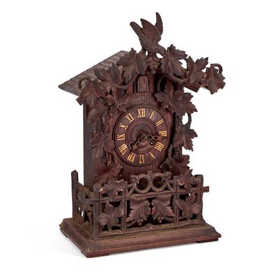 Lot 709 - A BLACK FOREST CARVED OAK CUCKOO SHELF CLOCK