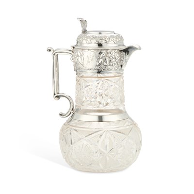 Lot 242 - AN EDWARDIAN SILVER-MOUNTED CUT-GLASS CLARET JUG