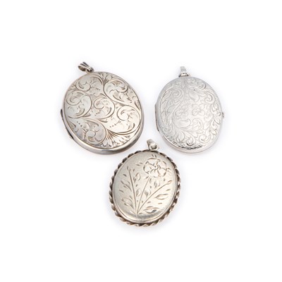 Lot 406 - THREE SILVER FOLIATE ENGRAVED OVAL LOCKET PENDANTS