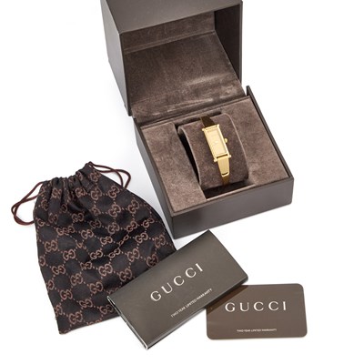 Lot 142 - A LADY'S GOLD PLATED GUCCI BANGLE WATCH