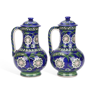 Lot 35 - A PAIR OF IZNIK STYLE EWERS AND COVERS