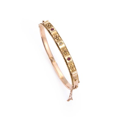Lot 493 - A 9 CARAT GOLD RED SPINEL AND DIAMOND HINGE OPENING BANGLE