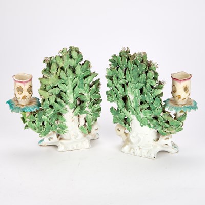 Lot A PAIR OF 19TH CENTURY CHELSEA DERBY STYLE BOCAGE FIGURAL CANDLESTICKS