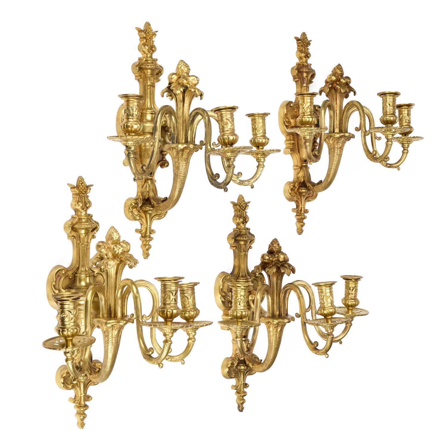 Lot A GOOD SET OF FOUR GILT-BRONZE THREE-LIGHT WALL SCONCES