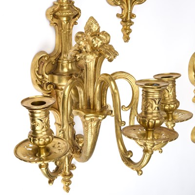 Lot A GOOD SET OF FOUR GILT-BRONZE THREE-LIGHT WALL SCONCES