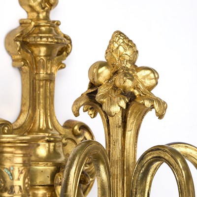 Lot A GOOD SET OF FOUR GILT-BRONZE THREE-LIGHT WALL SCONCES