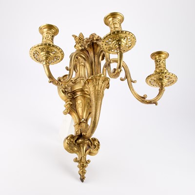 Lot A GOOD SET OF FOUR GILT-BRONZE THREE-LIGHT WALL SCONCES