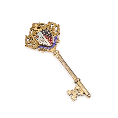 Lot 407 - AN EDWARDIAN SILVER-GILT AND ENAMEL PRESENTATION KEY