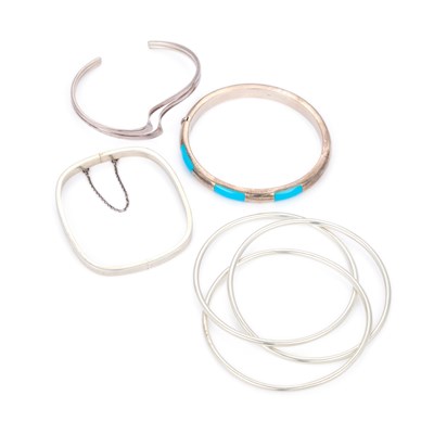 Lot 715 - THREE SILVER BANGLES AND ANOTHER BANGLE