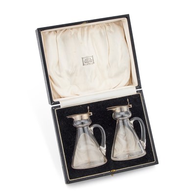 Lot 409 - A PAIR OF SILVER-MOUNTED GLASS WHISKY NOGGINS