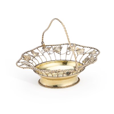 Lot 207 - AN EARLY GEORGE III SILVER-GILT SWING HANDLE BASKET