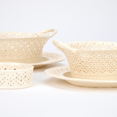 Lot A PAIR OF LEEDS POTTERY CREAMWARE BASKETS ON STANDS