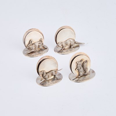 Lot 409 - A SET OF FOUR GEORGE V SILVER NOVELTY MENU HOLDERS