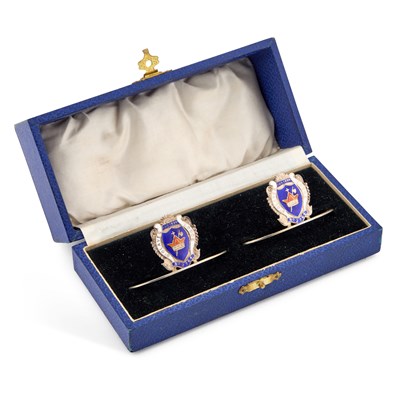 Lot A PAIR OF GEORGE V SILVER AND ENAMEL NAPKIN RINGS