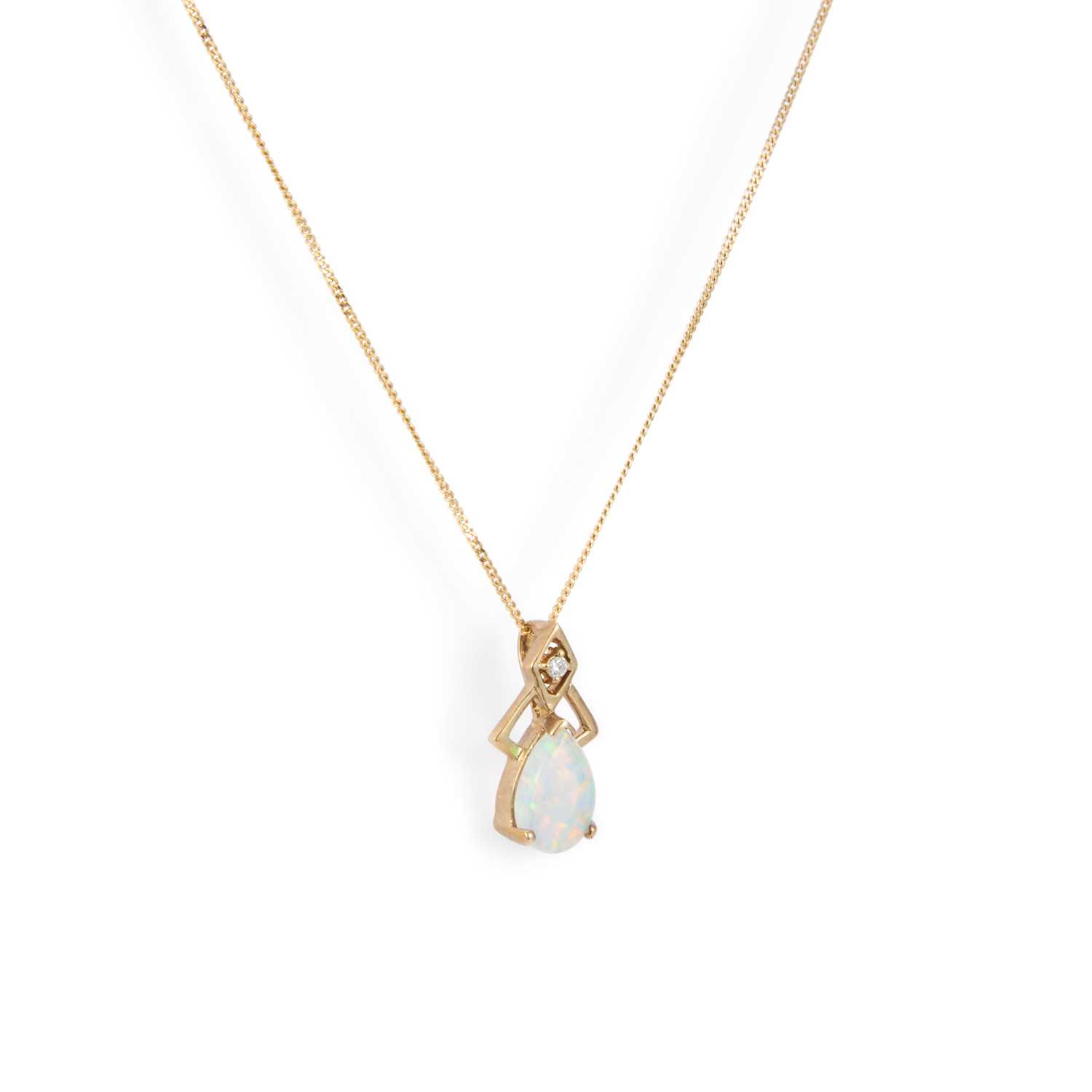 Lot 653 - A SYNTHETIC OPAL AND DIAMOND PENDANT ON A 9 CARAT GOLD CHAIN