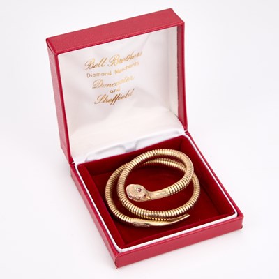 Lot 650 - A 9 CARAT GOLD COILED SNAKE BANGLE