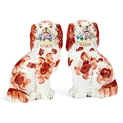 Lot A PAIR OF VICTORIAN STAFFORDSHIRE POTTERY MODELS OF FLOWER BASKET SPANIELS