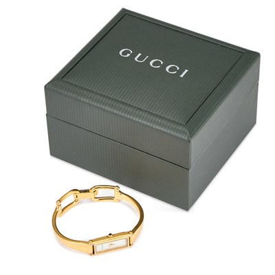 Lot 621 - A LADY'S GOLD PLATED GUCCI BANGLE WATCH