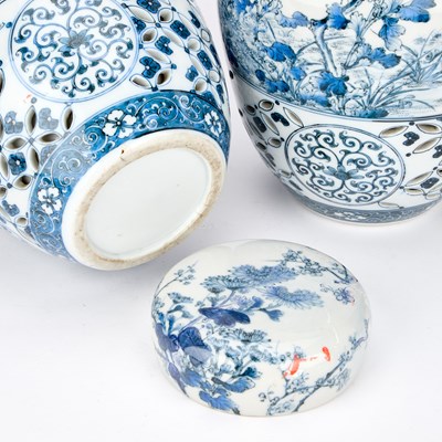 Lot 674 - A PAIR OF JAPANESE RETICULATED PORCELAIN GINGER JARS AND COVERS