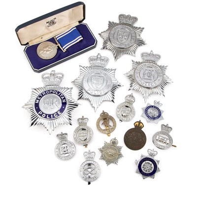 Lot 17 - AN ELIZABETH II POLICE LONG SERVICE AND GOOD CONDUCT MEDAL AND POLICE HELMET PLATES AND BADGES