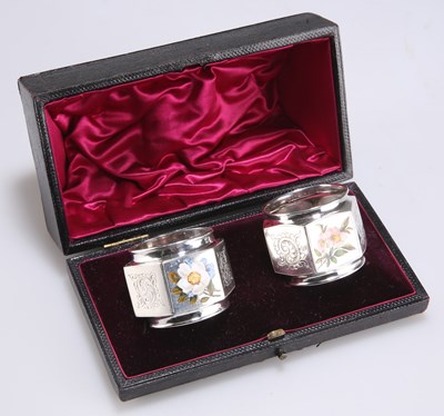 Lot 1364 - A PAIR OF VICTORIAN SILVER AND ENAMEL NAPKIN RINGS