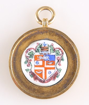 Lot A GEORGE V SILVER-GILT AND ENAMEL 'HARROGATE' FOB MEDALLION