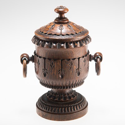 Lot 502 - A 19TH CENTURY CARVED OAK TOBACCO JAR AND COVER