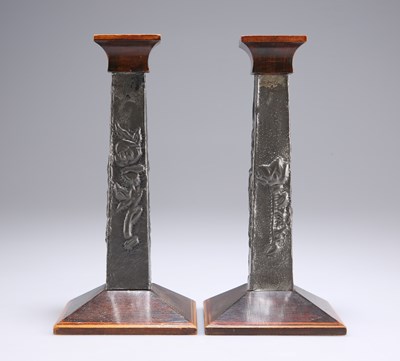 Lot 80 - A PAIR OF ARTS AND CRAFTS PEWTER-MOUNTED WOODEN CANDLESTICKS