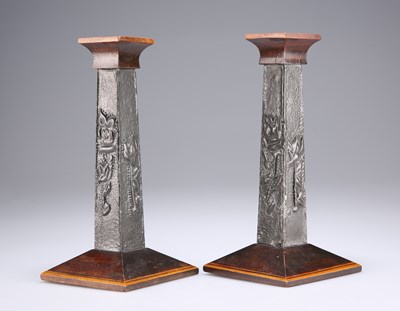 Lot 80 - A PAIR OF ARTS AND CRAFTS PEWTER-MOUNTED WOODEN CANDLESTICKS